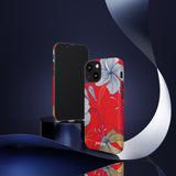 Loulii Blossom™ phone case that shows elegant flowers in white  with a red background on a stand showing front and back