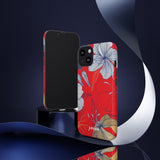Loulii Blossom™ phone case that shows elegant flowers in white  with a red background on a stand showing front and back