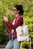 Missy Girl Organic Canvas Tote in natural color that shows a cute doll like girl picking flowers held by a women outdoors that is on her phone