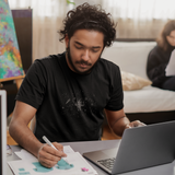 Male  on a computer wearing a Louliibot Robo tee