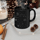LouliiBot™ Space Friends Mug in black on a table next to pine cones