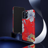 Loulii Blossom™ phone case that shows elegant flowers in white  with a red background on a stand showing front and back