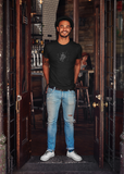 Man wearing a LouliiBot Robo2 T-Shirt in black standing in a doorway of a bar
