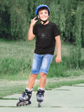 Kid wearing a black t-shirt with a cute robot on it roller skating 